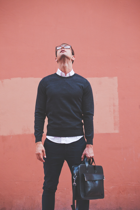 Business man looking up - orange background