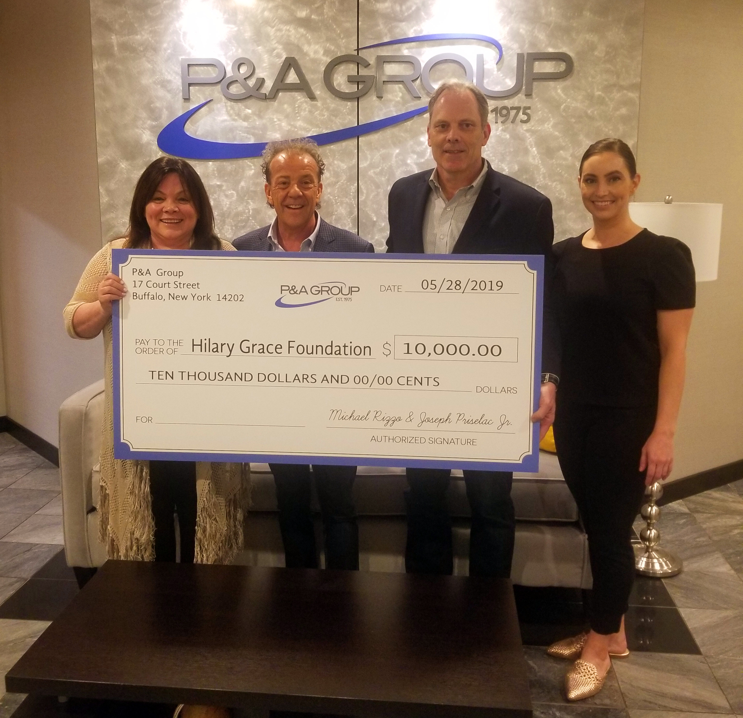 Company presents donation check to non-profit organization.